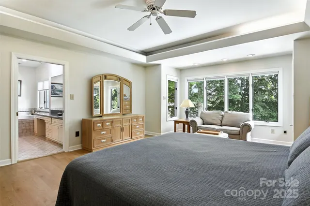 a spacious bedroom with a large bed and a large window