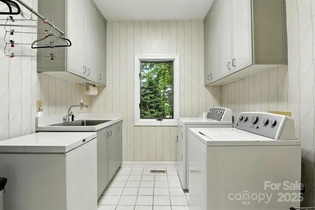 a utility room with sink dryer and washer