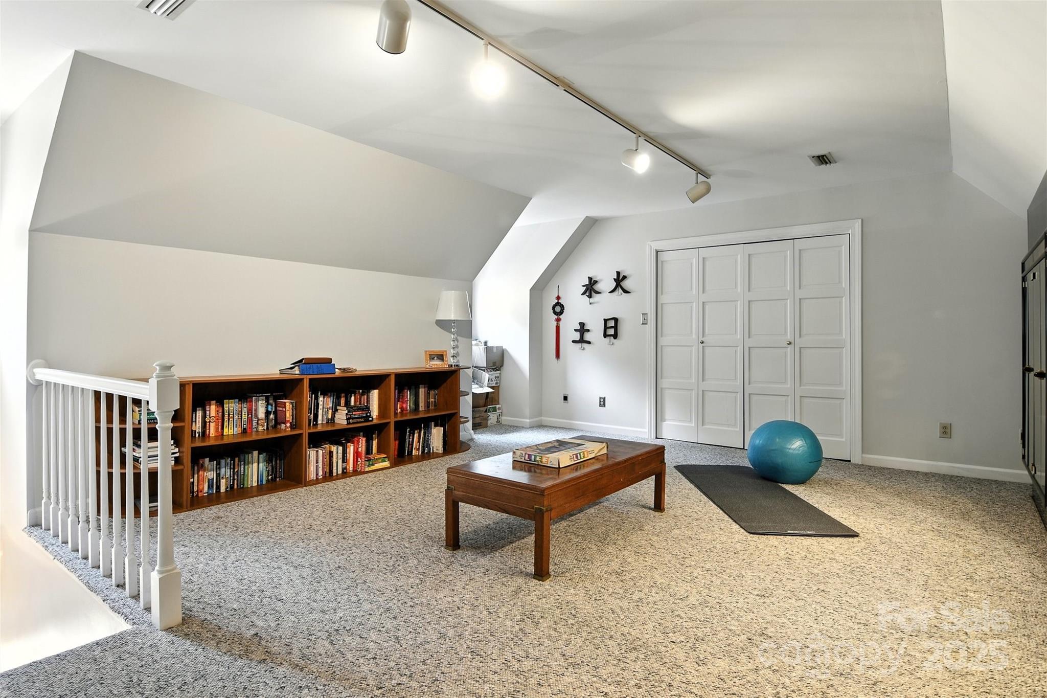 5042 Ridge Land Drive Hickory, NC 28602 - Photo 25 of 46 a living room with furniture and a book shelf
