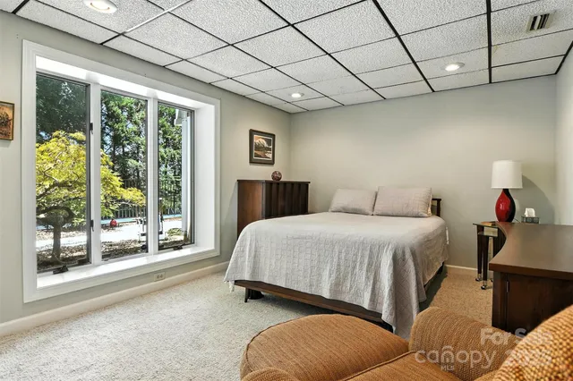 a spacious bedroom with a bed and a large window