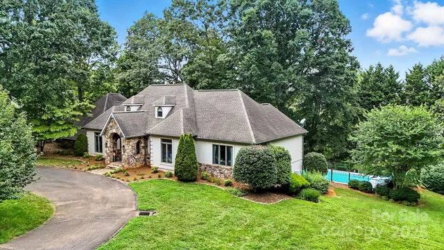an aerial view of a house with swimming pool and garden space