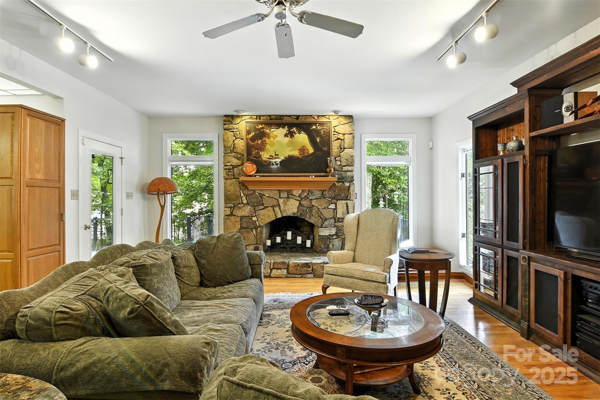 5042 Ridge Land Drive Hickory, NC 28602 - Photo 5 of 46 a living room with furniture a fireplace and a flat screen tv