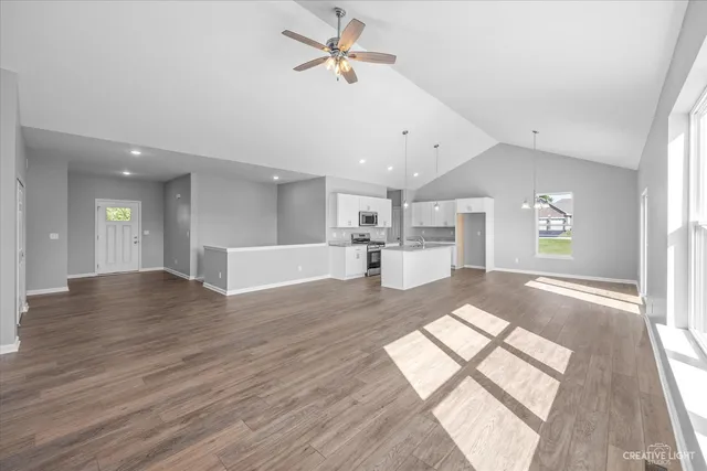 a view of kitchen and hall with wooden floor