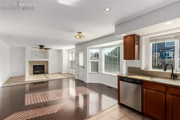 a kitchen with granite countertop a sink and a window