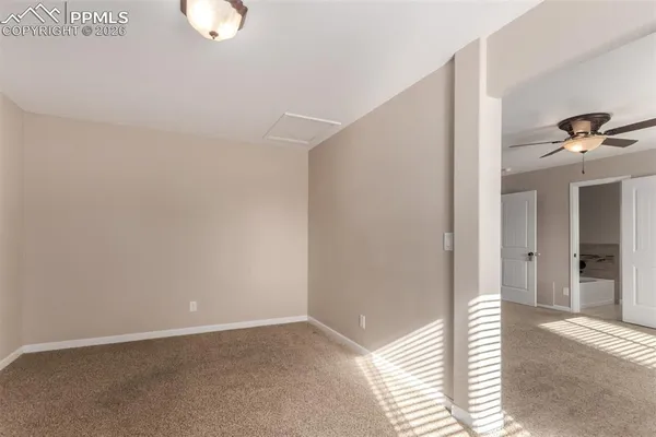 a view of a livingroom with a fireplace and window