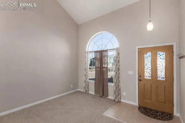 an empty room with closet and windows