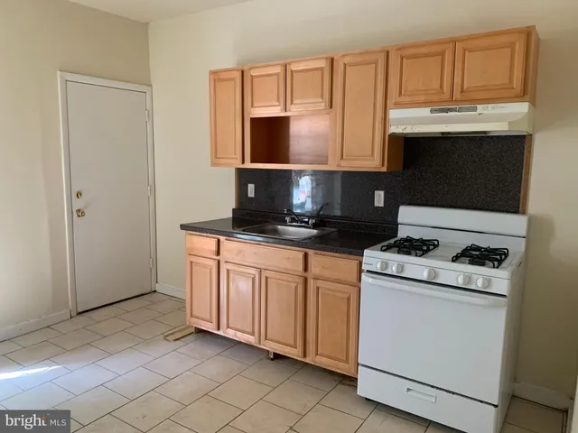 a kitchen with stainless steel appliances granite countertop a stove a microwave and a refrigerator