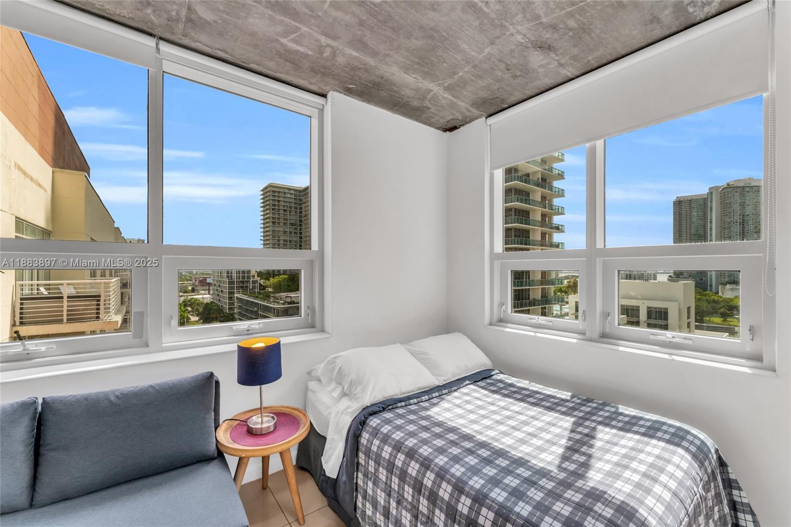 3250 Northeast 1st Avenue, Unit 1120 Miami, FL 33137 - Photo 13 of 39 a bedroom with a bed and wooden floor