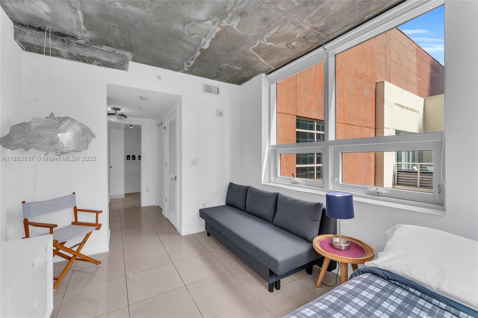 3250 Northeast 1st Avenue, Unit 1120 Miami, FL 33137 - Photo 14 of 39 a living room with furniture and a window