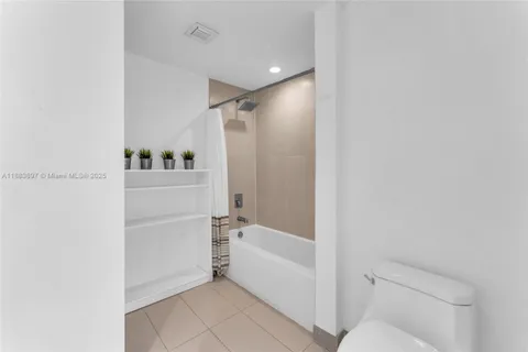 a bathroom with a tub and shower