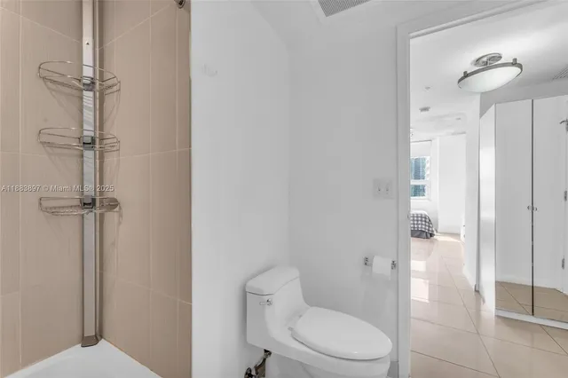 a bathroom with a toilet and a shower