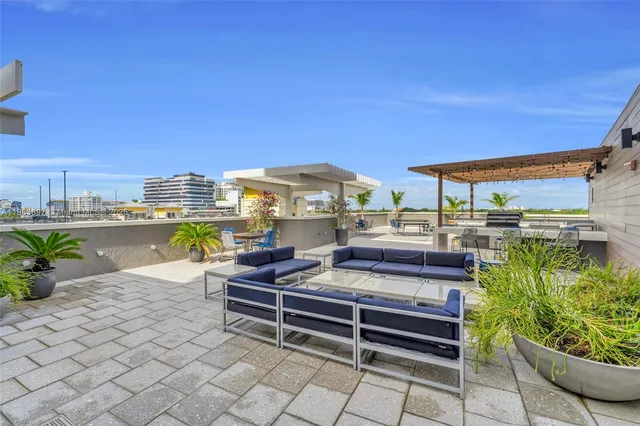 a view of a patio with plants and chairs