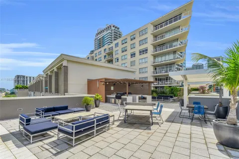 a building outdoor space with patio furniture and potted plants
