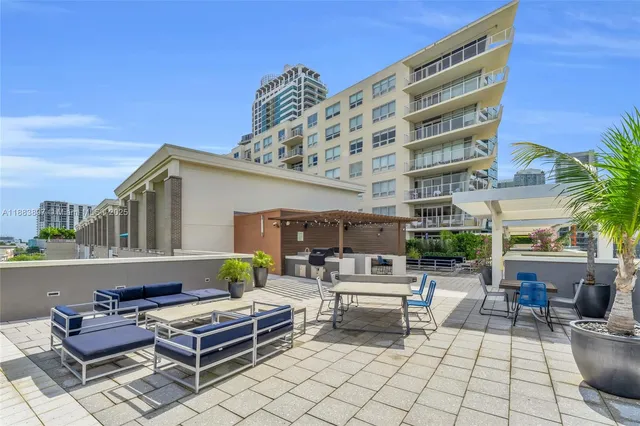 a building outdoor space with patio furniture and potted plants