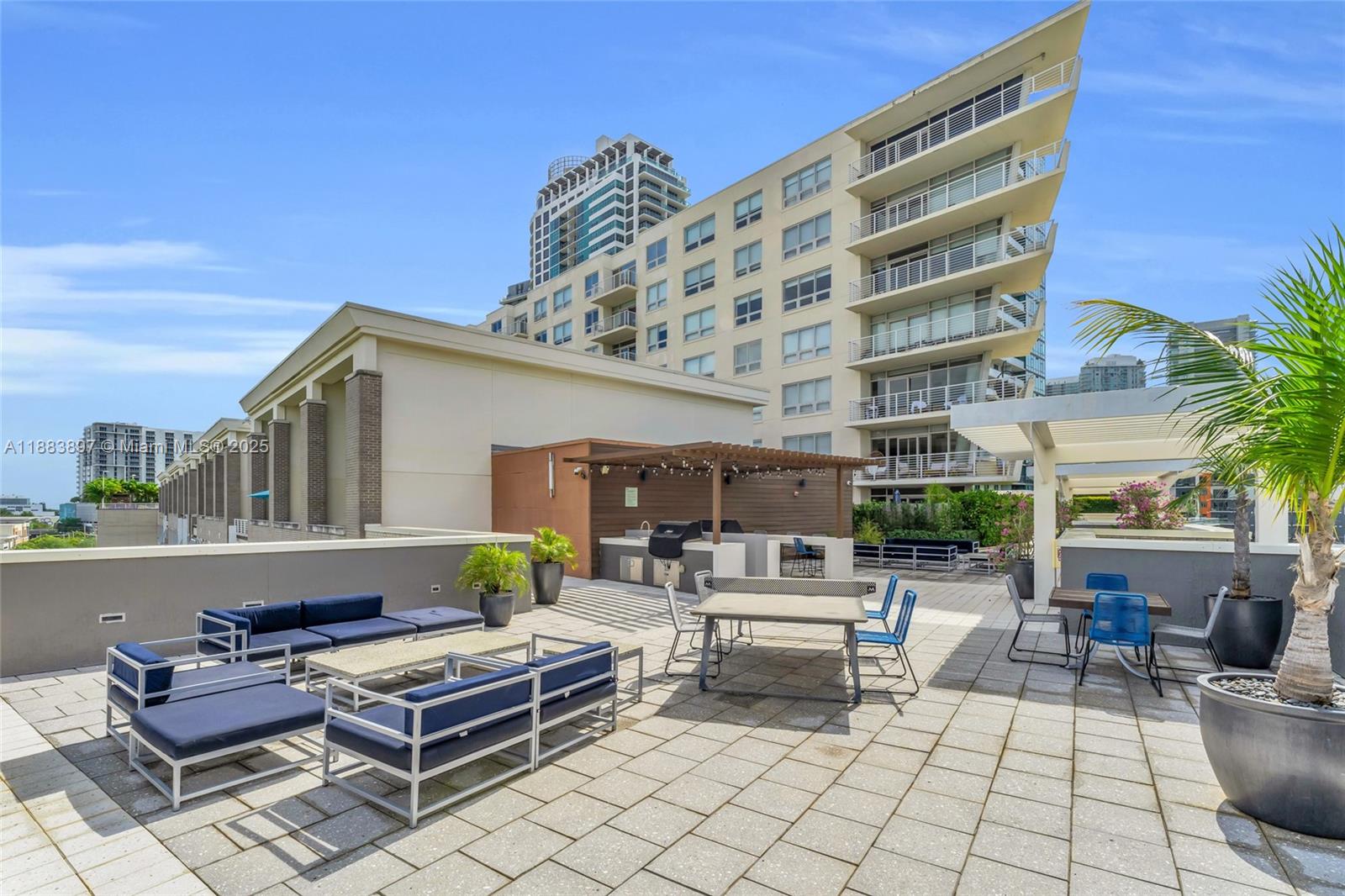 3250 Northeast 1st Avenue, Unit 1120 Miami, FL 33137 - Photo 28 of 39 a building outdoor space with patio furniture and potted plants
