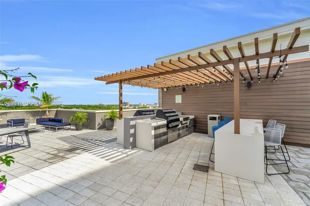 a view of a patio with a dining table and chairs with wooden floor