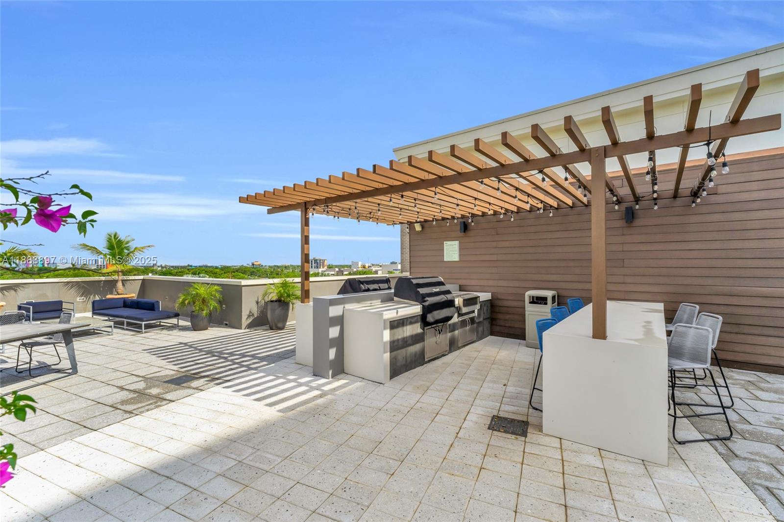 3250 Northeast 1st Avenue, Unit 1120 Miami, FL 33137 - Photo 29 of 39 a view of a patio with a dining table and chairs with wooden floor