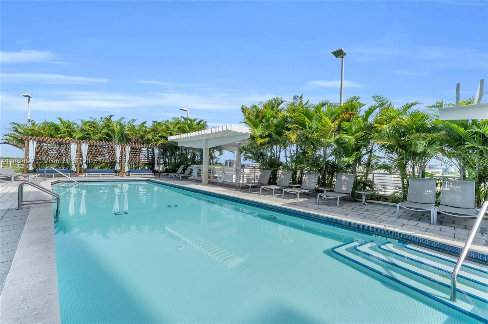 3250 Northeast 1st Avenue, Unit 1120 Miami, FL 33137 - Photo 31 of 39 a view of a swimming pool with a patio