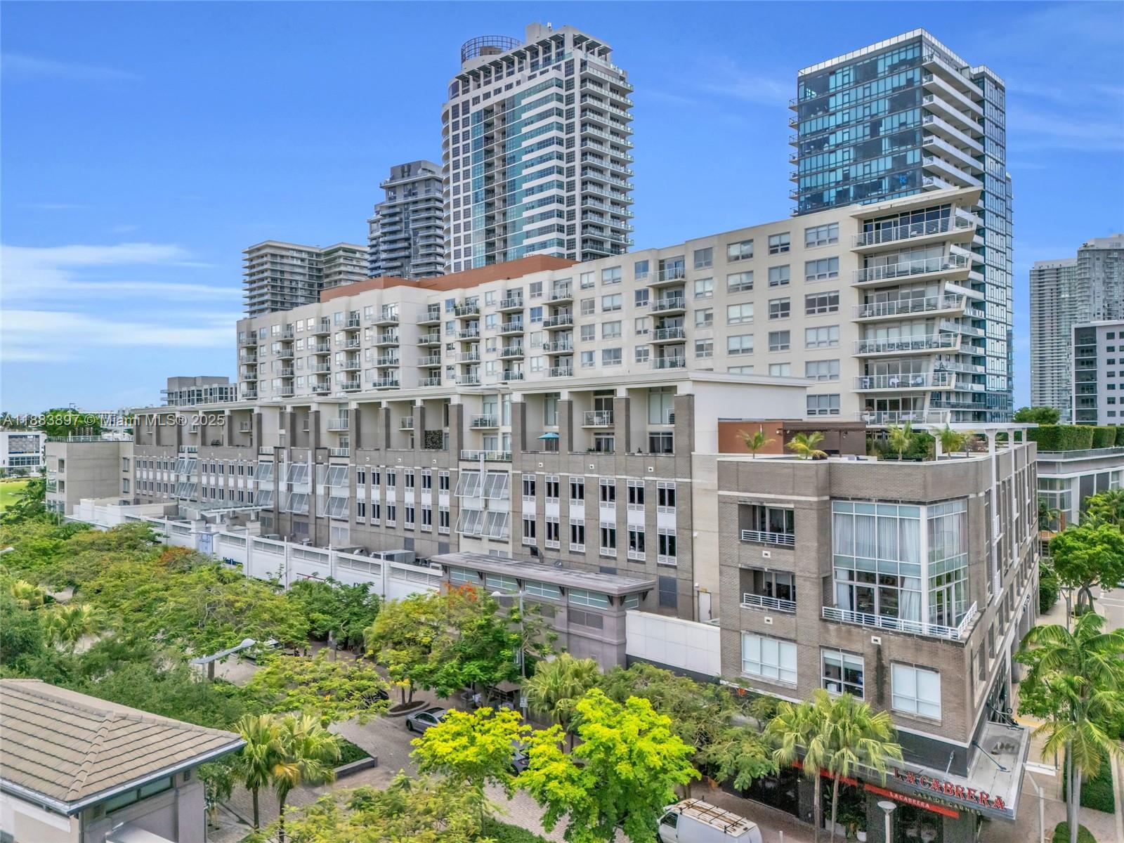 3250 Northeast 1st Avenue, Unit 1120 Miami, FL 33137 - Photo 38 of 39 a large building with a bench in front of it