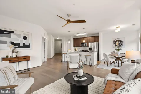 a living room with furniture and kitchen view