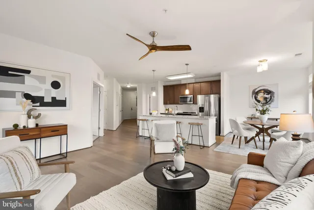 a living room with furniture and kitchen view