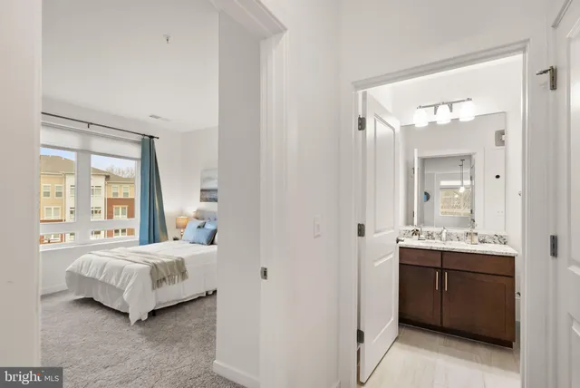 a bedroom with a bed and a large mirror