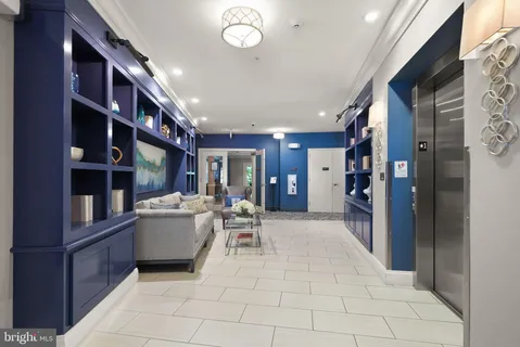 a living room with furniture and a book shelf