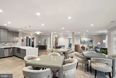 a large kitchen with a table and chairs