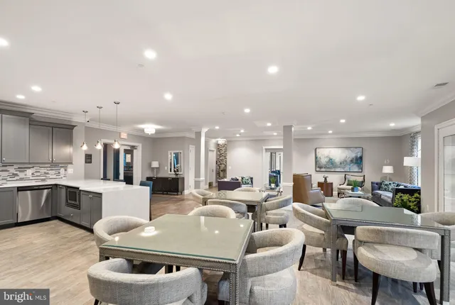 a large kitchen with a table and chairs