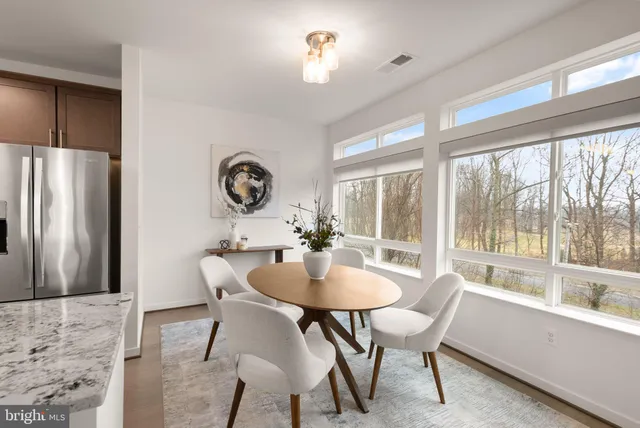 a view of a dining room with furniture window and outside view