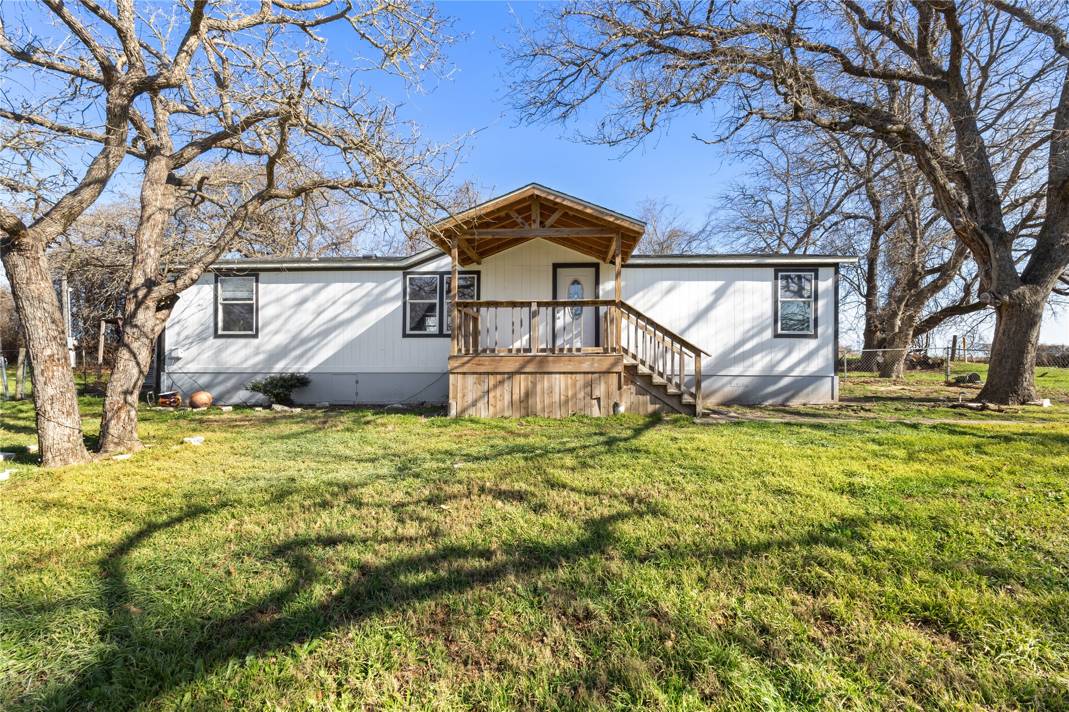 1029 Old McDade Road, Unit C Elgin, TX 78621 - Photo 1 of 33 a front view of a house with a yard and garage
