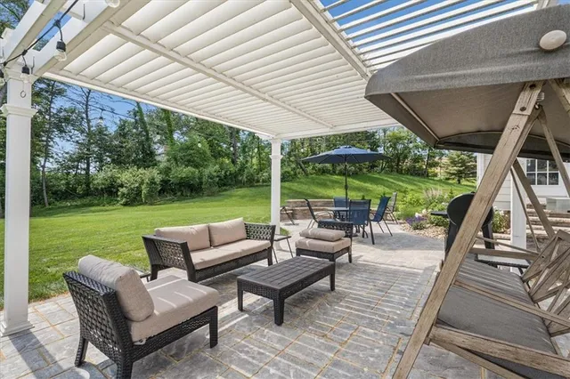 a view of patio with chairs and backyard