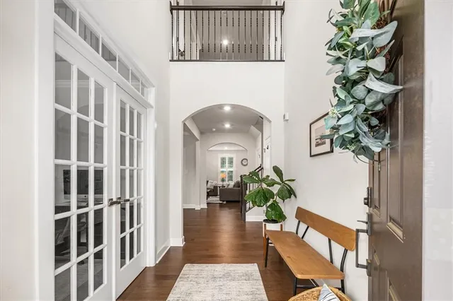 a view of entryway and hall with wooden floor