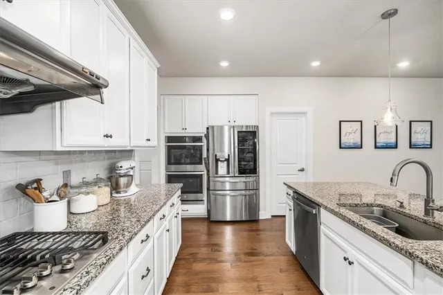 a view of a kitchen cabinets and wooden floor