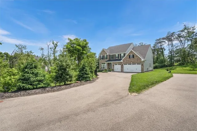 a view of a street with a house in the background
