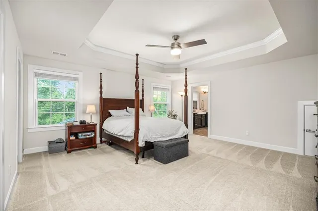 a bathroom with a double vanity sink a mirror and a bathtub