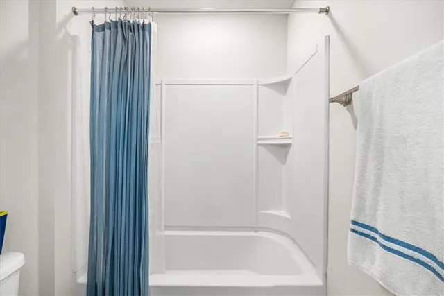 a spacious bedroom with a bed and window