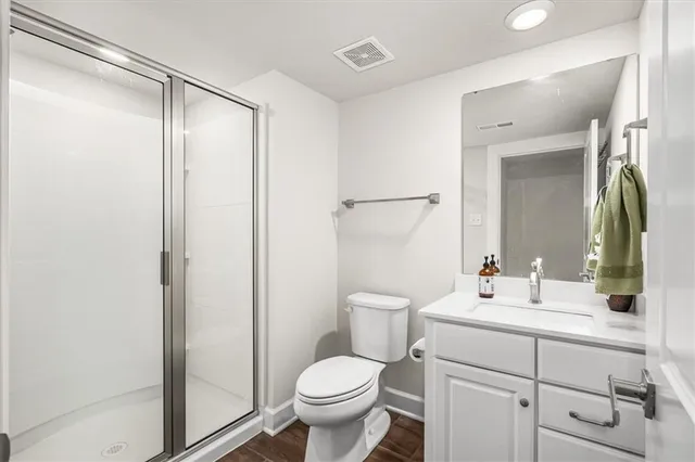 a view of a yard with flower plants and wooden fence
