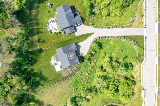 an aerial view of a house with a garden and lake view