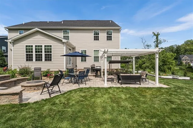a view of a house with a yard and sitting area