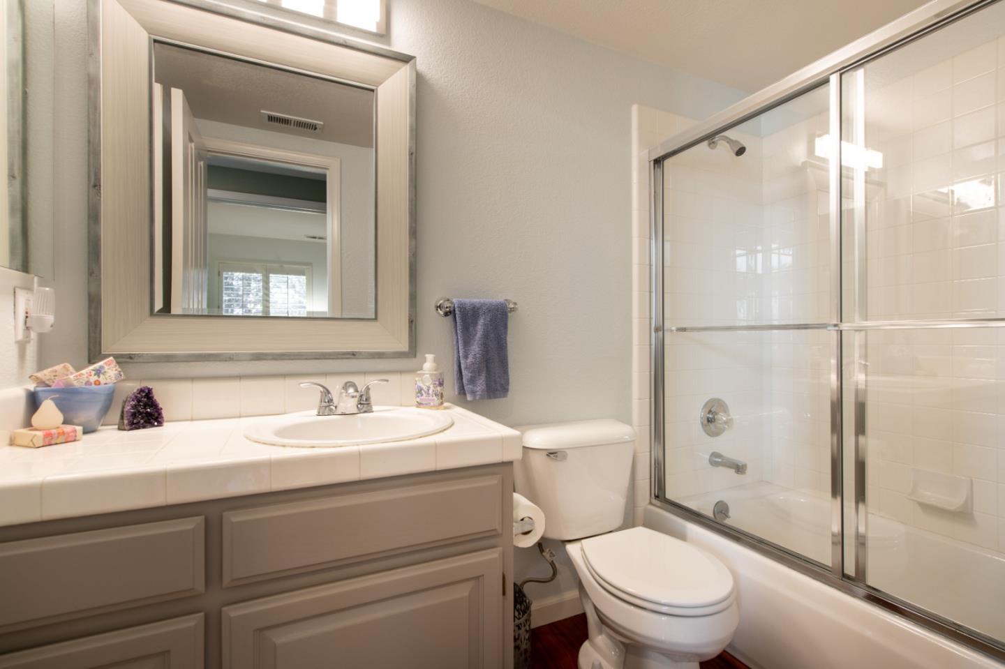 132 Patrick Way Half Moon Bay, CA 94019 - Photo 18 of 22 a bathroom with a sink a mirror a toilet and shower