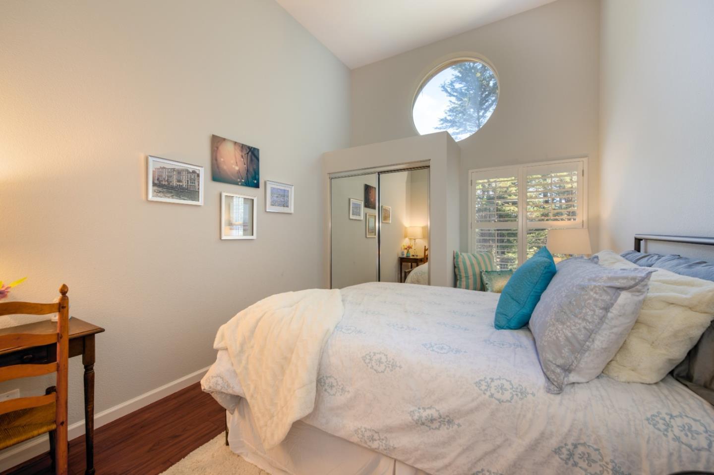 132 Patrick Way Half Moon Bay, CA 94019 - Photo 19 of 22 a bedroom with a bed and a chandelier