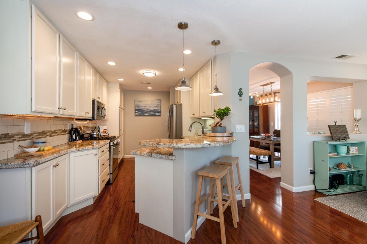 132 Patrick Way Half Moon Bay, CA 94019 - Photo 10 of 22 a kitchen with stainless steel appliances a dining table chairs stove and cabinets