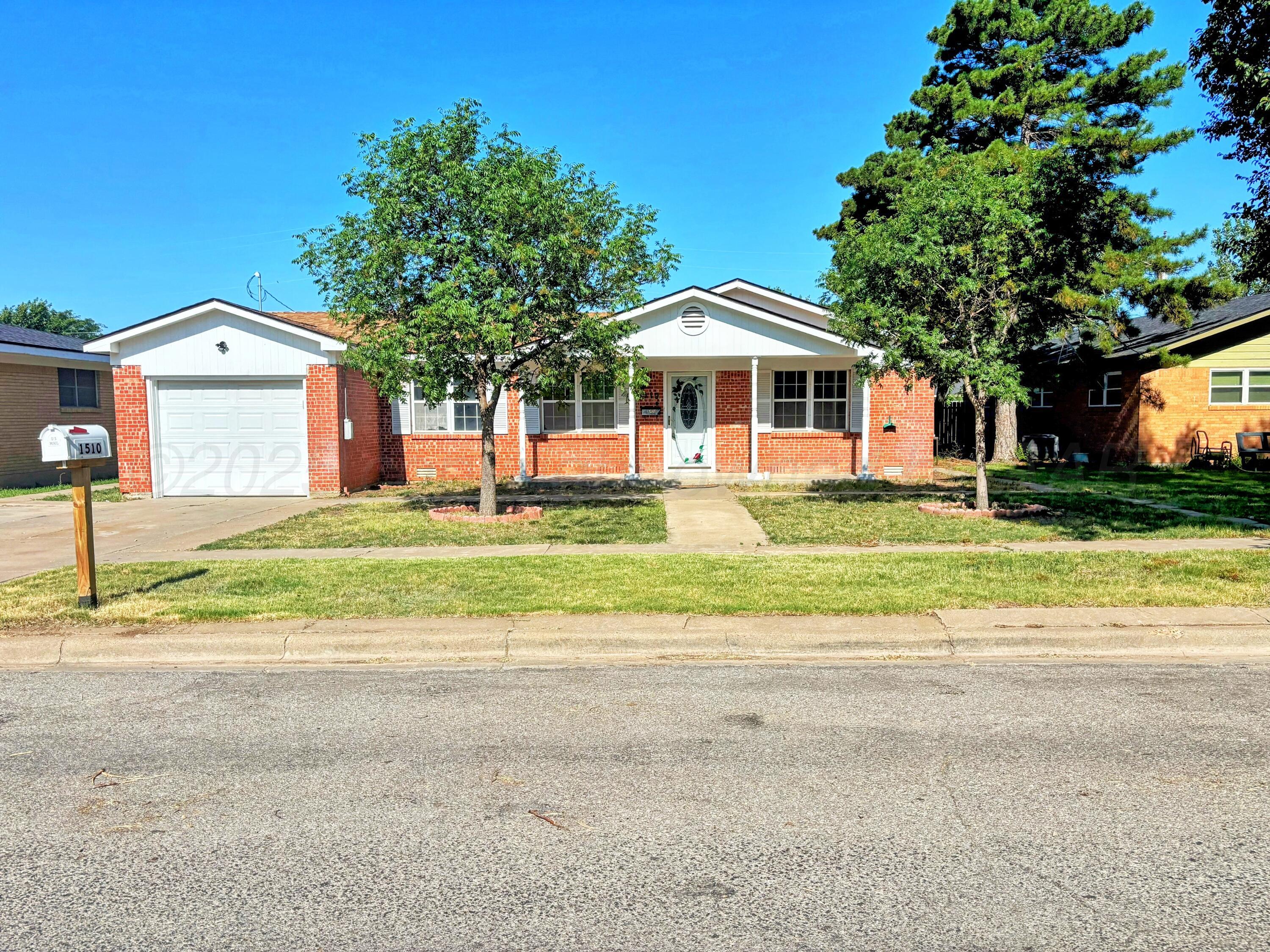 1510 South Indiana Street Perryton, TX 79070 - Photo 1 of 39 a front view of a house with a yard