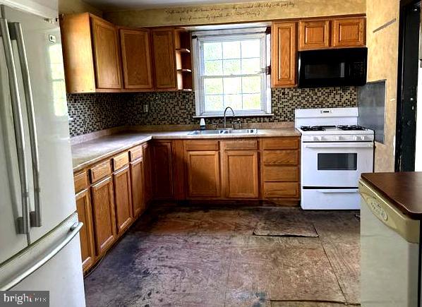6 Parkwood Road Baltimore, MD 21222 - Photo 25 of 30 a kitchen with granite countertop a stove a sink and a microwave