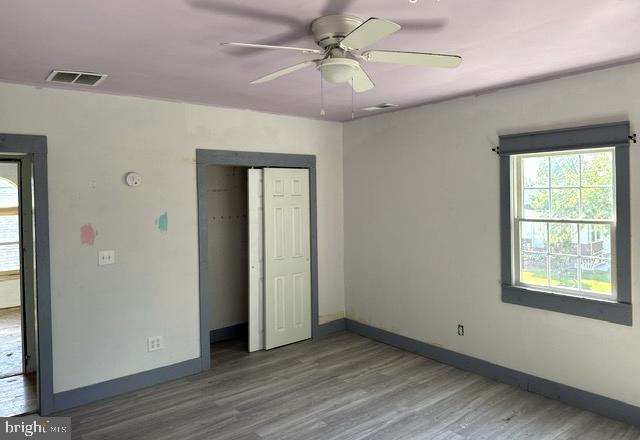 6 Parkwood Road Baltimore, MD 21222 - Photo 6 of 30 wooden floor in an empty room with a window