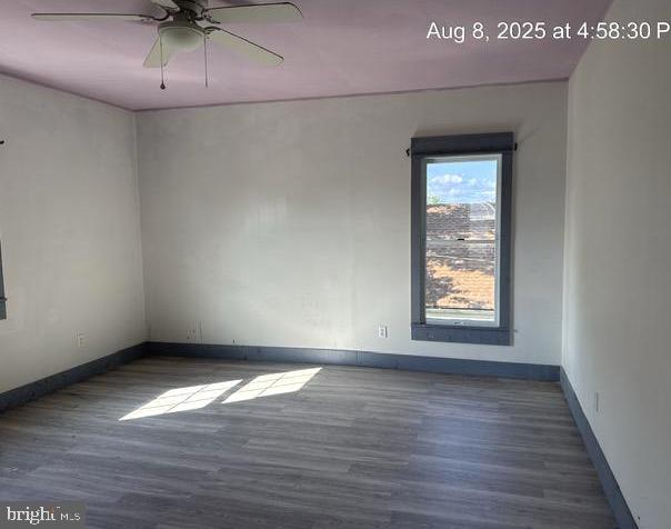 6 Parkwood Road Baltimore, MD 21222 - Photo 7 of 30 an empty room with wooden floor and windows