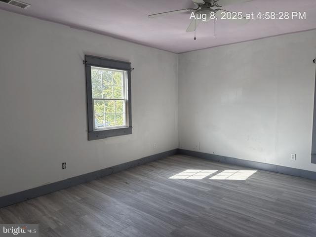 6 Parkwood Road Baltimore, MD 21222 - Photo 8 of 30 an empty room with wooden floor chandelier and windows
