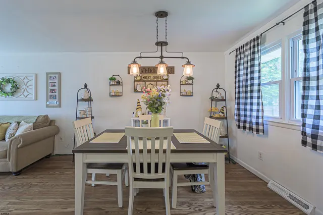 a view of a dining room with furniture window and wooden floor