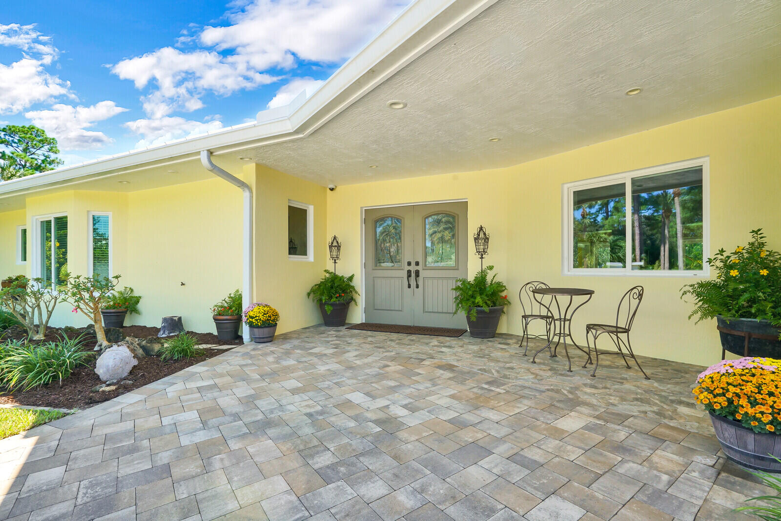 6624 Dillman Road Greenacres, FL 33413 - Photo 16 of 65 a view of a porch with chairs and potted plants